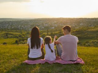 Scottish fostering family outside sitting on blanket