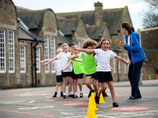 School children playing outdoor PE