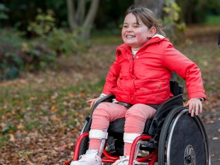 Young girl in red jacket outside