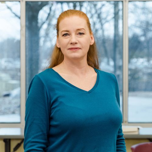 Elaine standing in front of a window