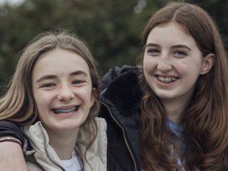 Two young Aberlour supported girls smiling.